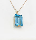 9ct Yellow Gold 16x25mm Emerald Cut Blue Topaz Pendant - Aurum Jewels